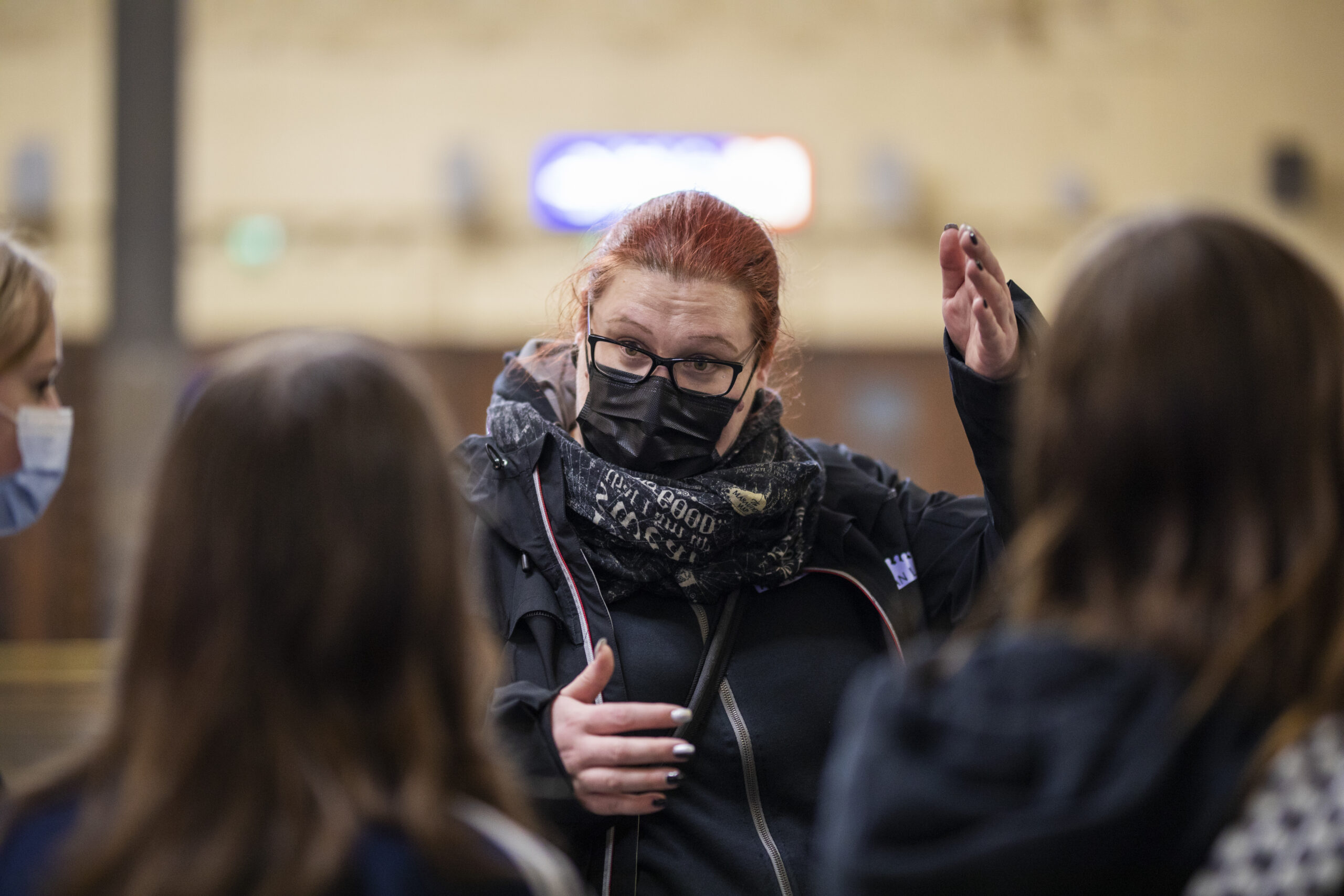 Turvallinen aikuinen juttelee nuorten kanssa, jotka ovat selin kameraan